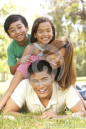 Asian Family Enjoying Day In Park Stock Photo