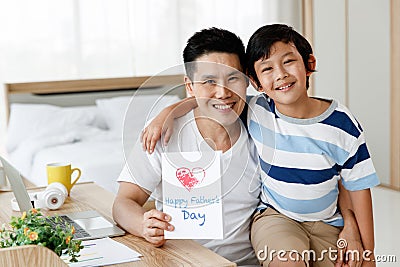 Asian family I love you, dad! Handsome man at home with his little boy. Happy Father`s Day. Concept Greeting card Stock Photo