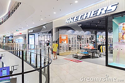 Asian family looking inside the Sketchers footwear and apparel store at Aeon Shopping Mall, Ha Dong Editorial Stock Photo