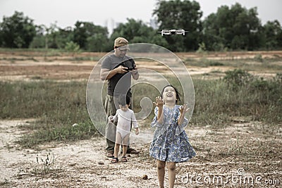 Asian family playing drone at the public park Stock Photo