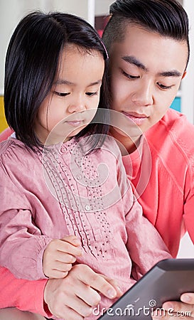 Asian family using tablet Stock Photo