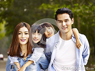 Asian family walking in park Stock Photo