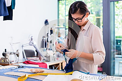 Asian fashion designer woman drafts cut pattern Stock Photo