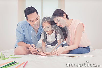 Asian father and mother teaching her daughter child Stock Photo