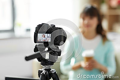 Asian female blogger with coffee recording video Stock Photo