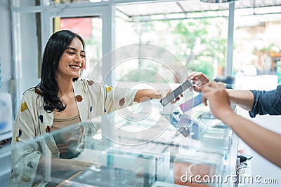 asian female customer smiling while choosing the vape mods Stock Photo