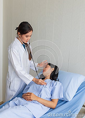 Asian female doctor examined the patient on a bed in the room Stock Photo