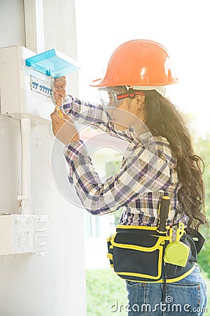 Asian female Electrician or Engineer check or Inspect Electrical system circuit Breaker. Stock Photo