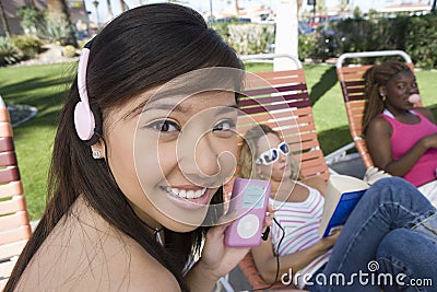 Asian Female Listening To Music On IPod Stock Photo