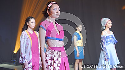 Asian female models wear colorful casual party outfits on the catwalk stage Editorial Stock Photo