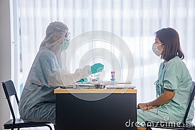 Asian Female Patient Being Reassured By Woman Doctor Stock Photo