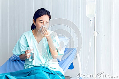 Asian female patients feel depressed Stay in bed waiting to be treated at the hospital Stock Photo