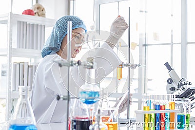 Asian female scientist during study chemicals Stock Photo