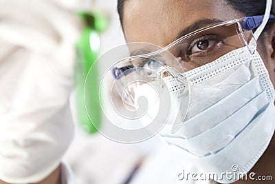 Asian Female Scientist & Test Tube of Green Liquid Stock Photo