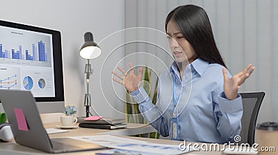 Asian female staff is shocked by the company`s sales decline Stock Photo