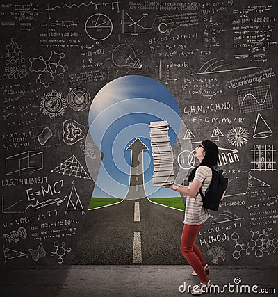 Asian female student bring books with success road and keyhole Stock Photo