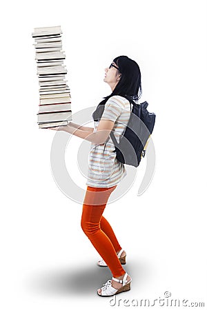 Asian female student bring pile of books - isolated Stock Photo