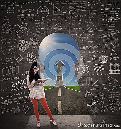 Asian female student reading book with success road Stock Photo