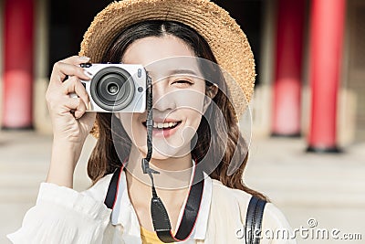 Asian female traveler photographing temples at Asia Stock Photo