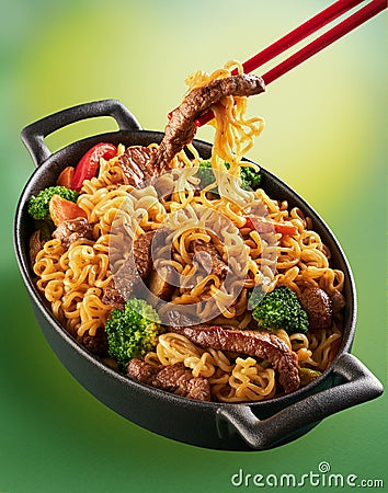 Asian food. Noodles with beef, broccoli, carrot in the metal pan. Doshirak with meat Stock Photo