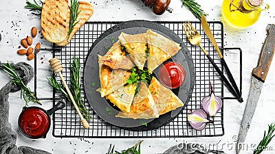 Asian food. Samsa with chicken and cheese on a black stone plate with ketchup. Rustic style. Stock Photo