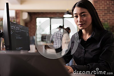 Asian freelance coder analyzing compiling html code Stock Photo