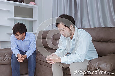 Asian gay couples are quarreling, angry or sad on sofa in home, LGBTQ concept. Stock Photo