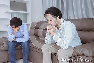 Asian gay couples are quarreling, angry or sad on sofa in home, LGBTQ concept. Stock Photo