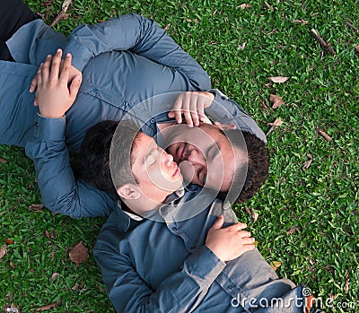 Asian gay couples sleep on the grass to make love happily and romantic Stock Photo