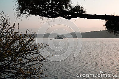 An Asian Gazebo in the middle of a tranquil lake Stock Photo