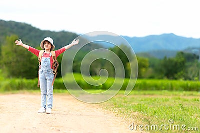 Asian girl children raise arms and standing see the outdoors, adventure and tourism for destination and leisure trips with mountai Stock Photo