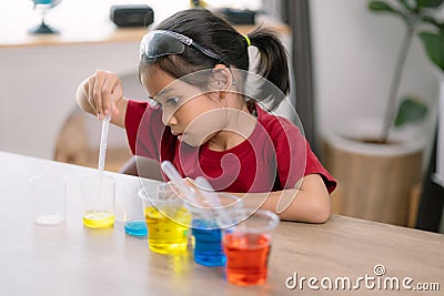 Asian girl doing chemical experiments at the lab Stock Photo