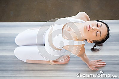 Asian girl doing Yoga in backward bending pose with eyes closed Stock Photo