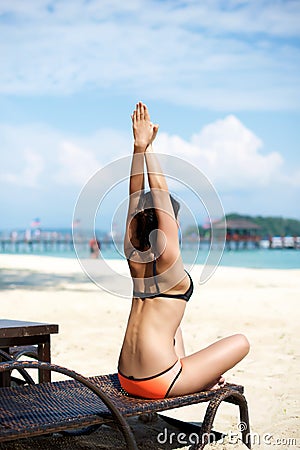 Asian girl doing Yoga on a recliner chair Stock Photo