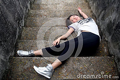 Asian girl fallen down steps Stock Photo