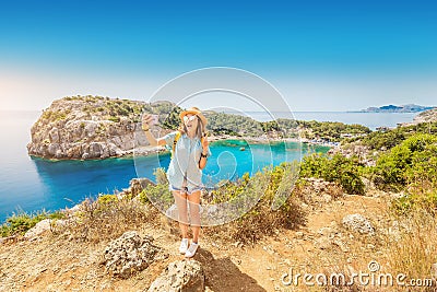 Girl in a hat takes a selfie on the background of stunning views of the azure Bay in the Mediterranean sea. Travel, vacation Stock Photo