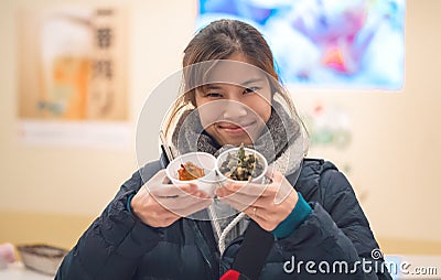 Asian girl having japanese Snack in a Izagaya bar and restuarant Stock Photo