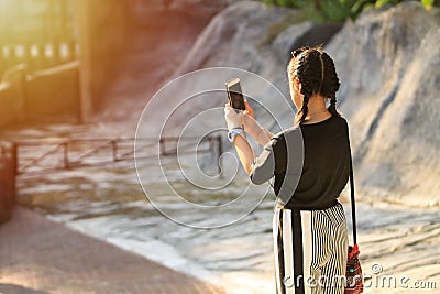 Asian girl Holding a smartphone, taking a selfie Stock Photo