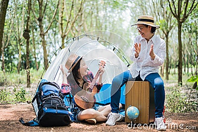 Asian girl and mother playing music in outdoors forest. People and lifestyles concept. Nature and Travel theme Stock Photo