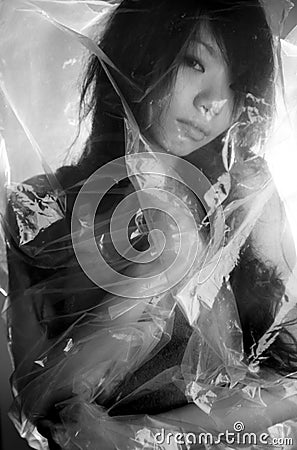 Asian girl in a plastic bag Stock Photo
