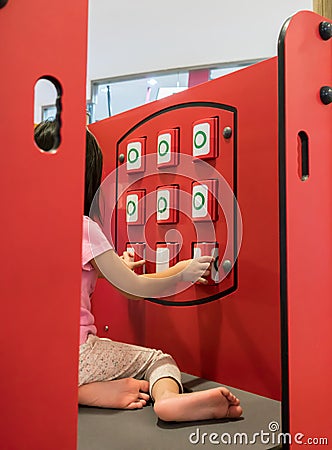 Asian girl playing Tic Tac Toe matching panel at playground Stock Photo