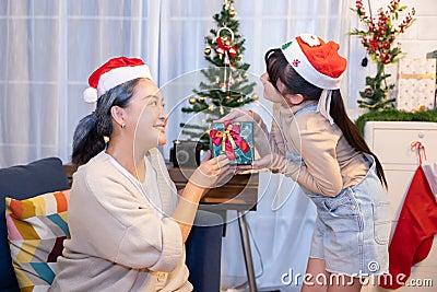 Asian girl received Christmas gift from her grandmom Stock Photo