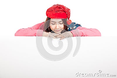 Asian girl with red christmas hat look down rest her chin on blank sign Stock Photo