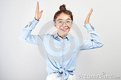 Excited kazakh asian girl clasped her hands opened mouth in surprise and bulged eyes against white background, . Portrait Stock Photo