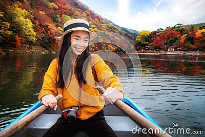 Asian girl relax by paddle and a rent boat on river in arashiyama park Stock Photo