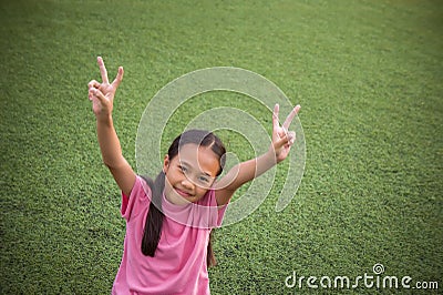 Asian girl`s siting and smile looking at on the artificial grass Stock Photo