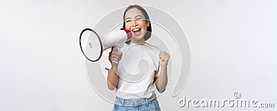 Asian girl shouting at megaphone, young activist protesting, using loud speakerphone, making announcement, white Stock Photo