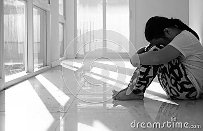 Asian girl sitting on floor at home. Bullying and isolation concept. Stock Photo