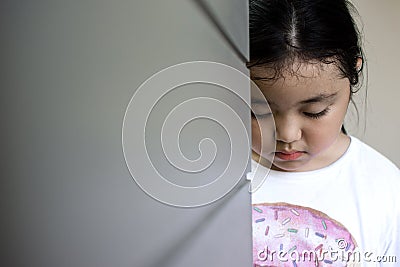 Asian girl sitting on floor at home. Bullying and isolation concept. Stock Photo