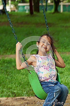 Asian girl swinging and smiling Stock Photo